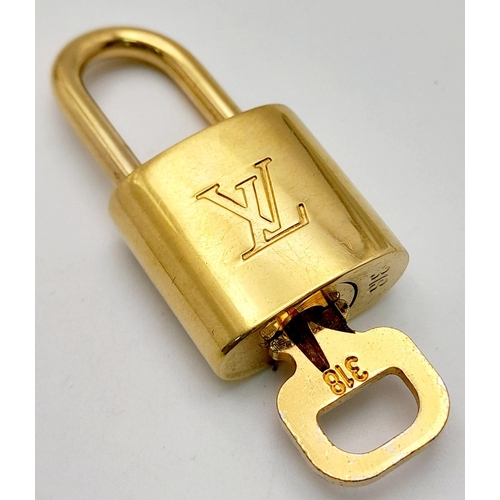 1580 - A Louis Vuitton Gold Plated Padlock and Key.