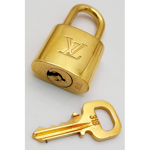 1580 - A Louis Vuitton Gold Plated Padlock and Key.