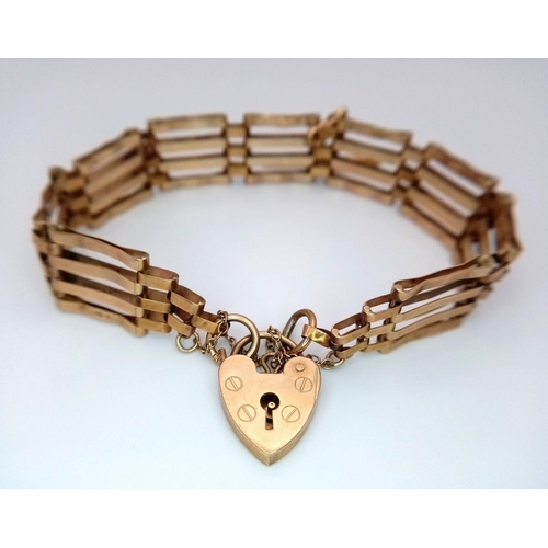 1545 - A Vintage 9K Yellow Gold Gate Bracelet with Heart Clasp. T-bar charm. 18cm. 10.68g weight.