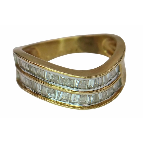 1216 - An 18K Yellow Gold Tapered Baguette Diamond Crest Ring. Two rows of undulating diamonds - 0.80ctw. S... 