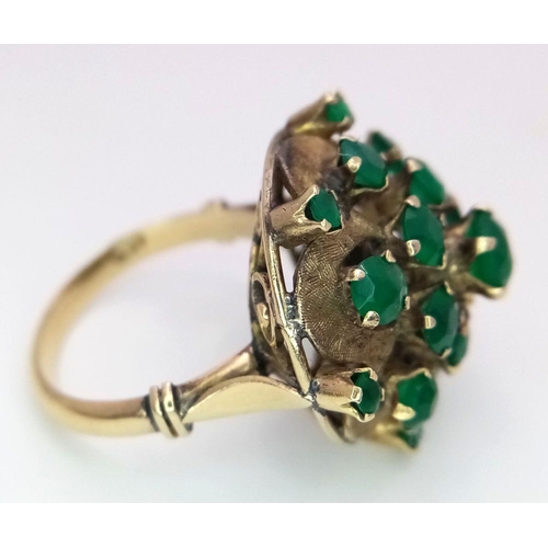 1278 - A Vintage 14k Yellow Gold Emerald Ring. 20 graduating emeralds in circular floral form. Size L 1/2. ... 