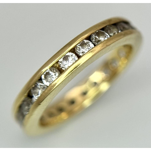 123 - AN 18K YELLOW GOLD DIAMOND SET FULL ETERNITY RING. 0.40CTW. 2.8G. SIZE H. SC5057