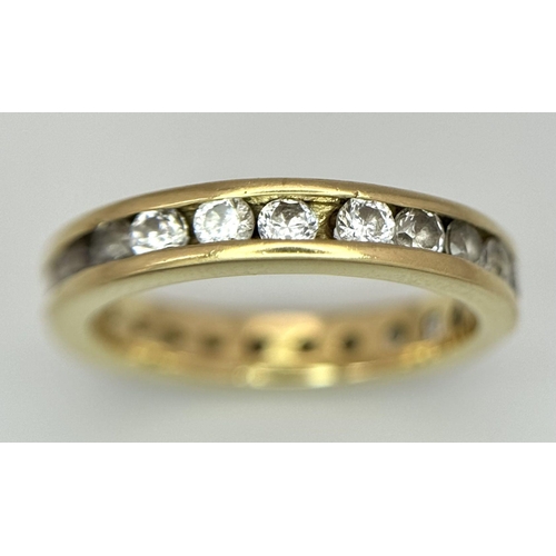 123 - AN 18K YELLOW GOLD DIAMOND SET FULL ETERNITY RING. 0.40CTW. 2.8G. SIZE H. SC5057