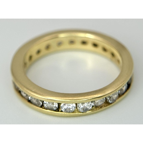 123 - AN 18K YELLOW GOLD DIAMOND SET FULL ETERNITY RING. 0.40CTW. 2.8G. SIZE H. SC5057