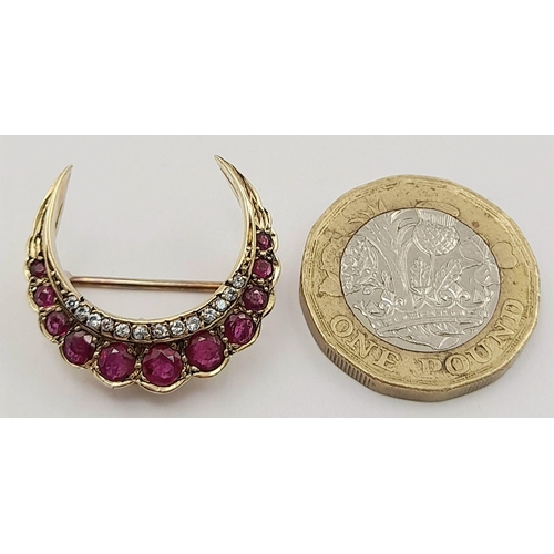 235 - A 9K YELLOW GOLD DIAMOND AND RUBY HALF MOON BROOCH. 3.9G. SC5016.