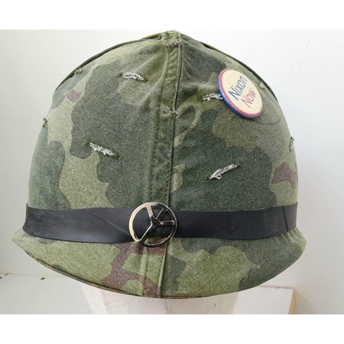 294 - A Vietnam War Era US M1 Helmet with liner and reversible camouflage Cover.