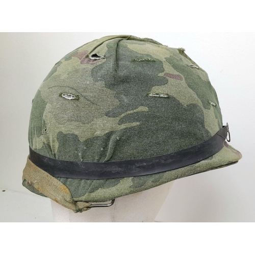 294 - A Vietnam War Era US M1 Helmet with liner and reversible camouflage Cover.