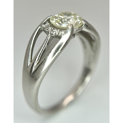 316 - A Stunning 900 Platinum 1.5ct (SI2) Tinted Yellow Diamond Ring. Brilliant round cut central diamond ... 