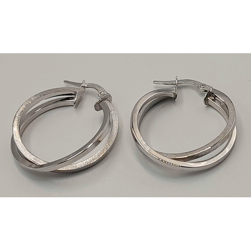 439 - A PAIR OF 9K WHITE GOLD FANCY DOUBLE CROOSOVER HOOP EARRINGS. 1.9G. SC5017