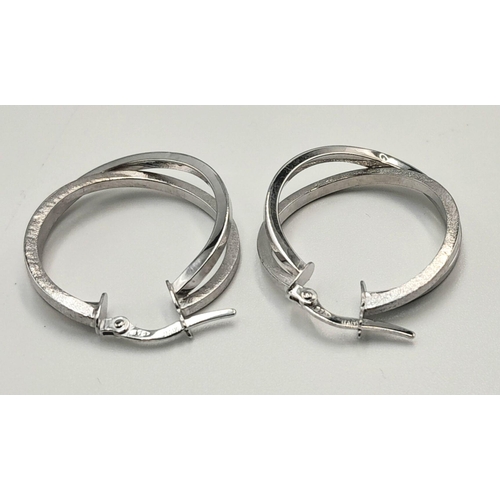 439 - A PAIR OF 9K WHITE GOLD FANCY DOUBLE CROOSOVER HOOP EARRINGS. 1.9G. SC5017