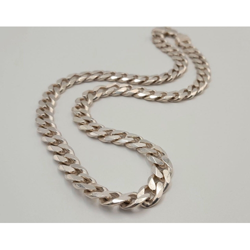 551 - A STERLING SILVER HEAVY CURB CHAIN.  50CM. 74G. SC5082.