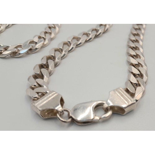 551 - A STERLING SILVER HEAVY CURB CHAIN.  50CM. 74G. SC5082.