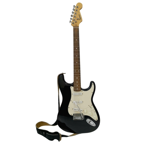 736 - A Squire Strat (by Fender) Six String Electric Black and White Guitar. Comes with a shoulder strap. ... 