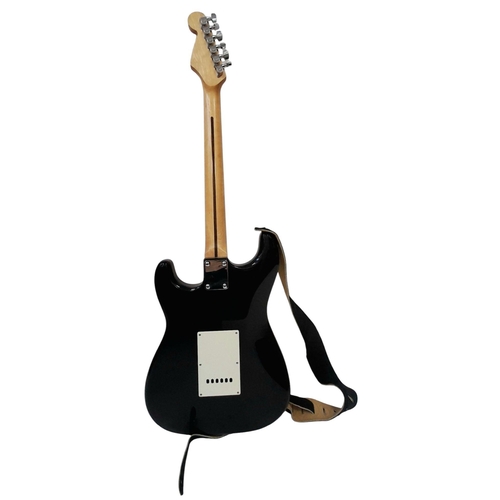 736 - A Squire Strat (by Fender) Six String Electric Black and White Guitar. Comes with a shoulder strap. ... 