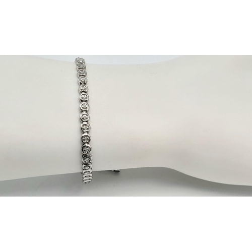 75 - A 9K WHITE GOLD DIAMOND SET TENNIS BRACELET. 0.50CTW. 8.1G TOTAL WEIGHT. 19CM. 48 DIAMONDS. 8797