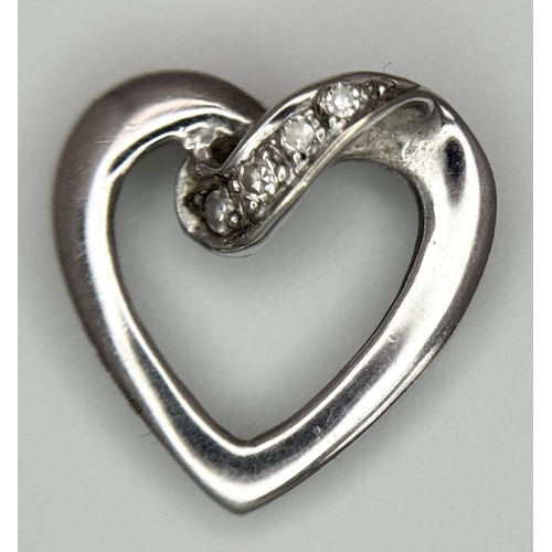 782 - A 9K WHITE GOLD DIAMOND SET OPEN HEART PENDANT. 0.7G. SC5037