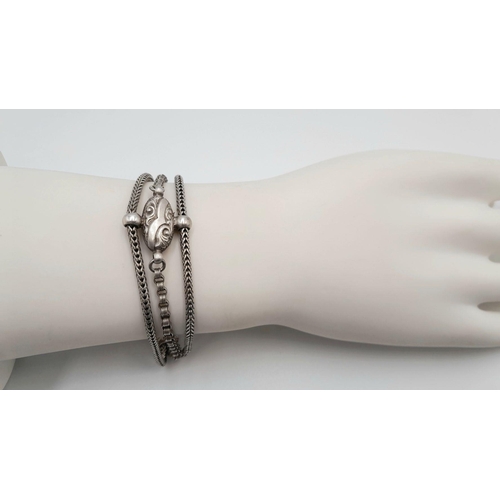 853 - A STERLING SILVER VINTAGE 3 ROW BRACELET - WITH TASSLE CHARM. 18.4G. 16CM. SC5081