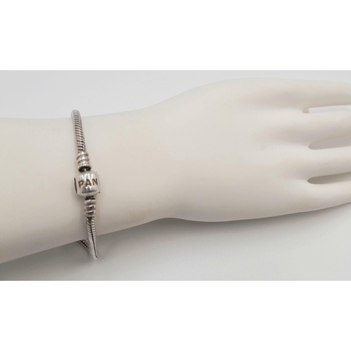 881 - A PANDORA STERLING SILVER MOMENTS BRACELET. 15.5G.
18CM. SC5090