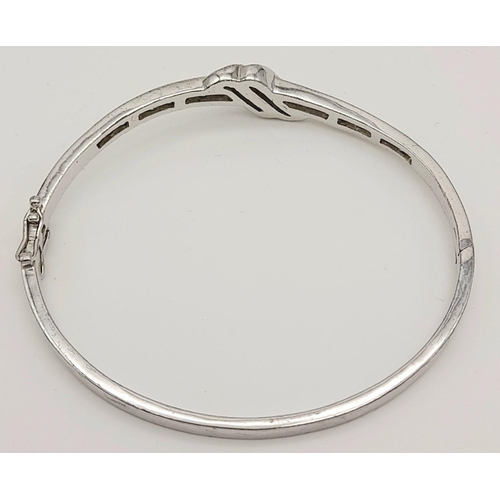 1000 - A STERLING SILVER STONE SET BANGLE - WITH DOUBLE SAFETY CATCH. 14.7G. SC5073