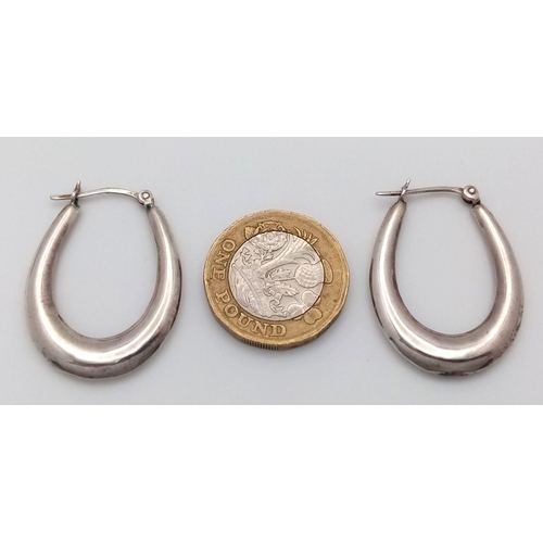 1014 - A PAIR OF STERLING SILVER OVAL SHAPED HOOP EARRINGS-3.7G. SC5075