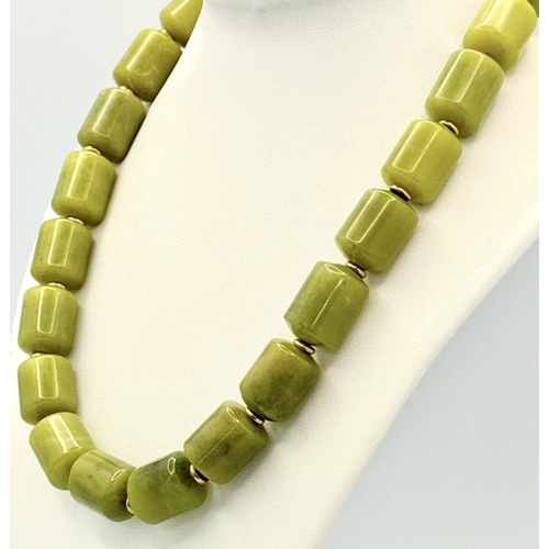 1319 - A Moss Green Jade Rondelle Beaded Necklace. Gilded spacers and clasp. 42cm.