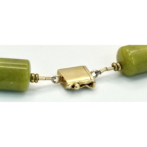 1319 - A Moss Green Jade Rondelle Beaded Necklace. Gilded spacers and clasp. 42cm.