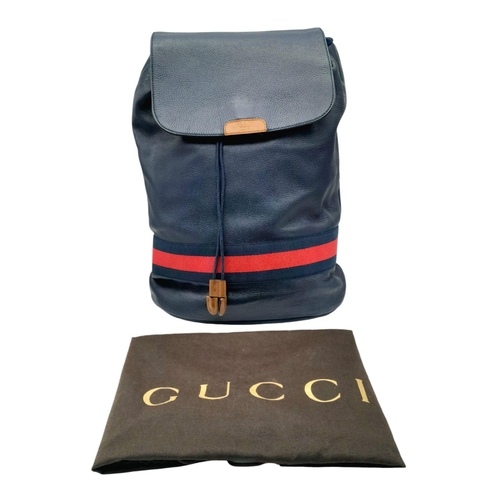 171 - A Gucci Black Leather Backpack. Black leather exterior with silver-toned hardware, navy and red stri... 