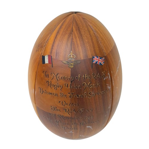 608 - A Wooden Rugby Ball and stand with a painted memorial to the famous game between the RAF and French ... 