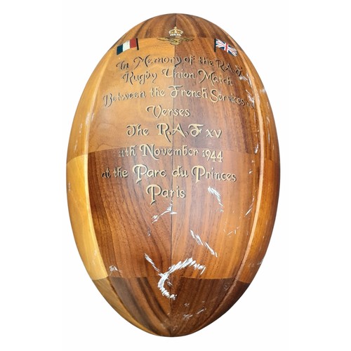 608 - A Wooden Rugby Ball and stand with a painted memorial to the famous game between the RAF and French ... 