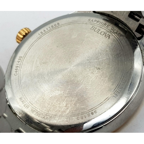 1293 - A BULOVA BI-METAL GENTS WATCH WITH MOTHER OF PEARL DIAL , QUARTZ MOVEMENT AND IN VERY GOOD CONDITION... 