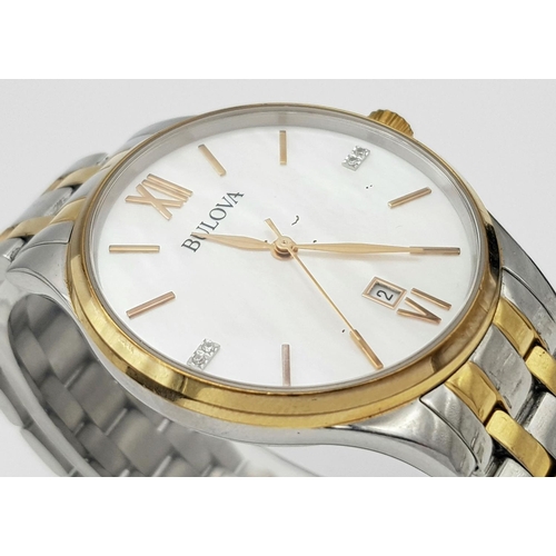 1293 - A BULOVA BI-METAL GENTS WATCH WITH MOTHER OF PEARL DIAL , QUARTZ MOVEMENT AND IN VERY GOOD CONDITION... 