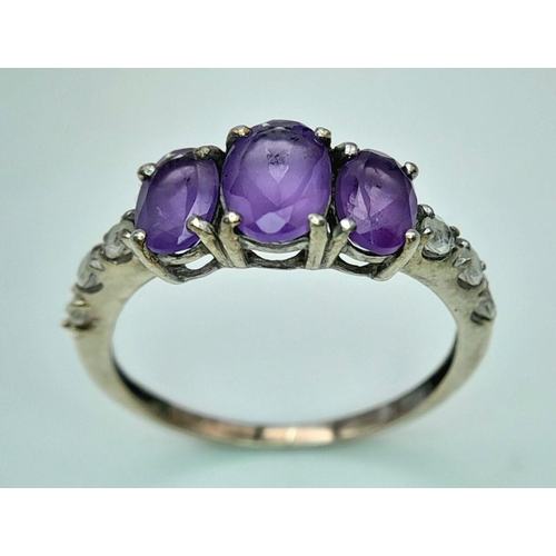 1027 - A Vintage Silver Amethyst and White Sapphire Set Ring Size P. The Ring is Set with Three Oval Cut Am... 