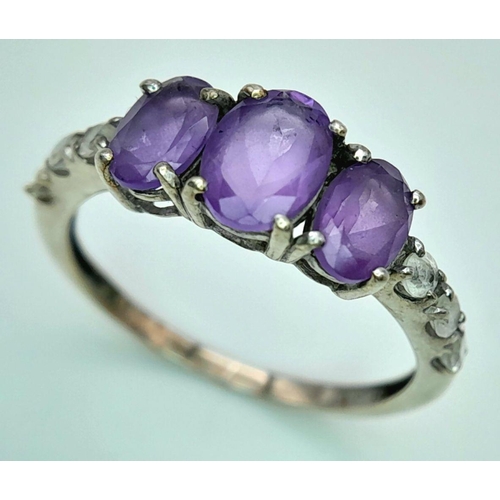 1027 - A Vintage Silver Amethyst and White Sapphire Set Ring Size P. The Ring is Set with Three Oval Cut Am... 