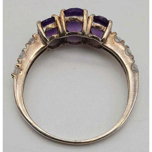 1027 - A Vintage Silver Amethyst and White Sapphire Set Ring Size P. The Ring is Set with Three Oval Cut Am... 