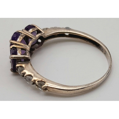 1027 - A Vintage Silver Amethyst and White Sapphire Set Ring Size P. The Ring is Set with Three Oval Cut Am... 