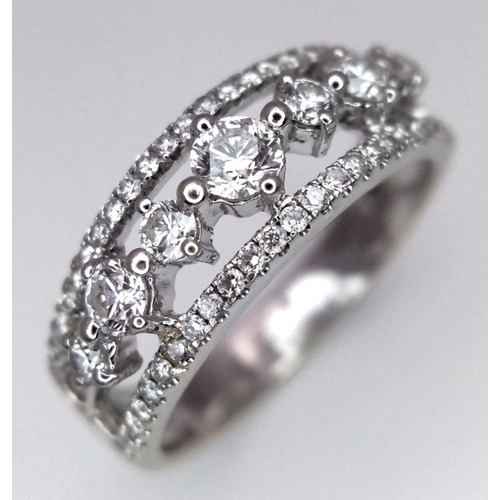 247 - A 14k White Gold and Diamond Three Row Ring. 1ctw of quality diamonds in brilliant and round cuts in... 