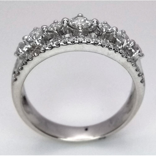 247 - A 14k White Gold and Diamond Three Row Ring. 1ctw of quality diamonds in brilliant and round cuts in... 