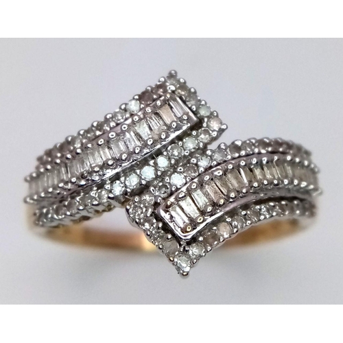 268 - A 9K Yellow Gold Diamond Crossover Ring. Six rows of tapered baguette and round cut diamonds create ... 