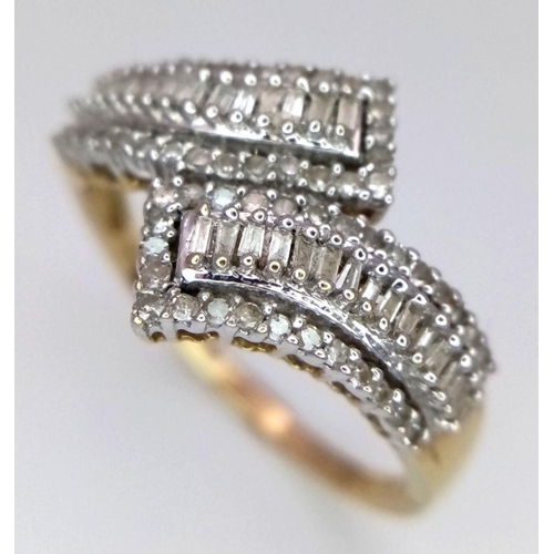 268 - A 9K Yellow Gold Diamond Crossover Ring. Six rows of tapered baguette and round cut diamonds create ... 