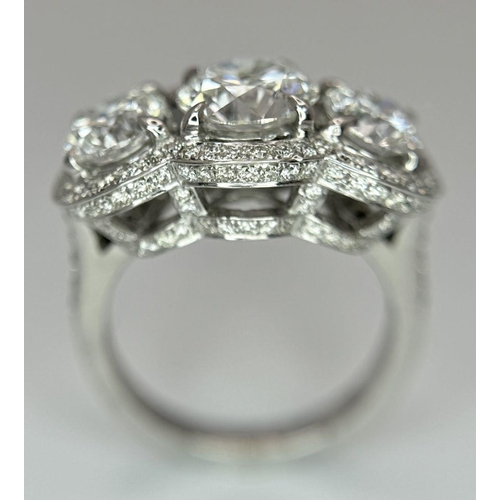 289 - A Head-Turning 18K White Gold and Lab Diamond Dress Ring. Three remarkable VS1 brilliant round cut d... 