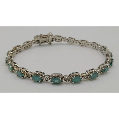 368 - A Sterling Silver Emerald and White Topaz Set Tennis Bracelet. 20cm Length. Set with Nineteen 5mm Re... 