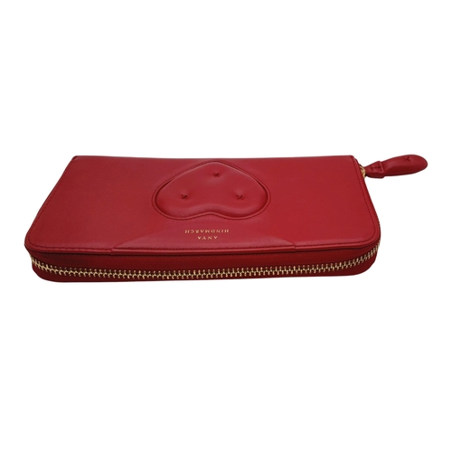 378 - An Anya Hindmarch Clutch Purse/Wallet. Red leather exterior with quilted heart. Zipped and open comp... 