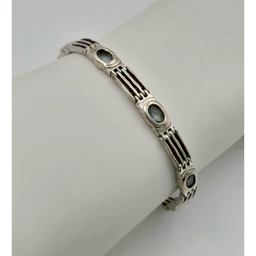 459 - A Vintage Sterling Silver Blue Topaz Set Tennis Bracelet. 19cm Length. Set with Eight 5mm Oval Cut B... 