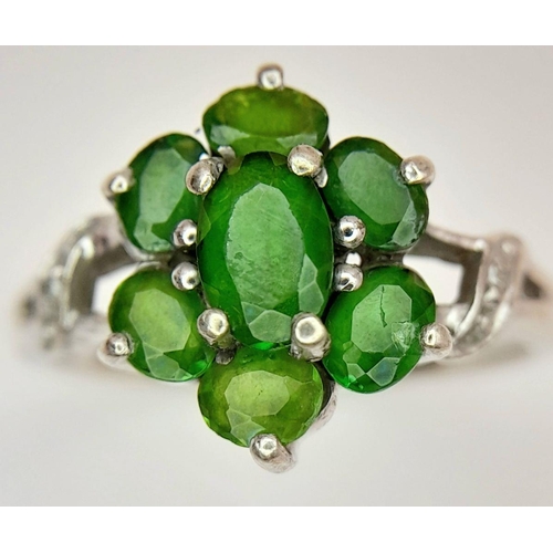 1055 - A Sterling Silver Green Garnet and Diamond Set Ring Size P. The Ring Measures 1.2cm Wide at the Crow... 