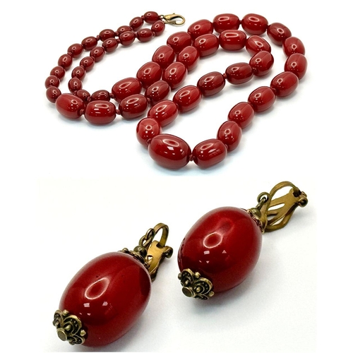 1391 - A graduated cherry resin necklace with matching drop earrings. Approx 101.5cm chain length, 4.5cm ea... 