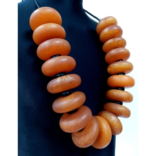 1559 - A Large Berber Amber Resin Necklace. 1074g total weight.