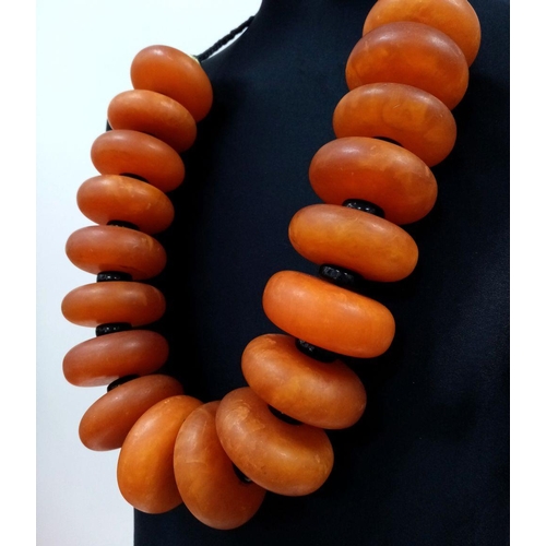 1559 - A Large Berber Amber Resin Necklace. 1074g total weight.