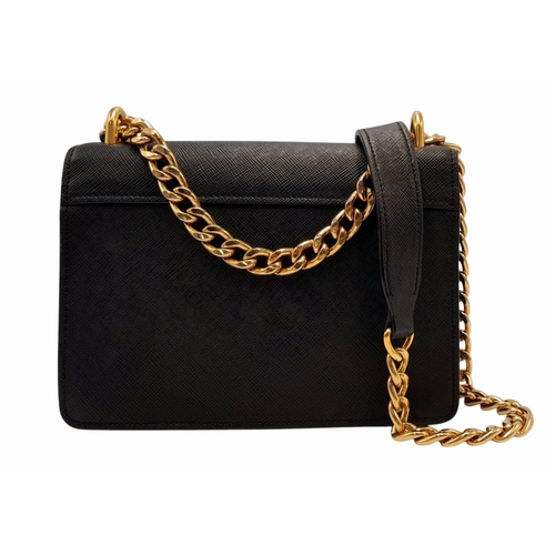 255 - A Prada Black Shoulder Bag. Saffiano leather exterior with gold-toned hardware, chain and leather st... 