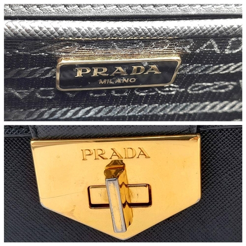 255 - A Prada Black Shoulder Bag. Saffiano leather exterior with gold-toned hardware, chain and leather st... 