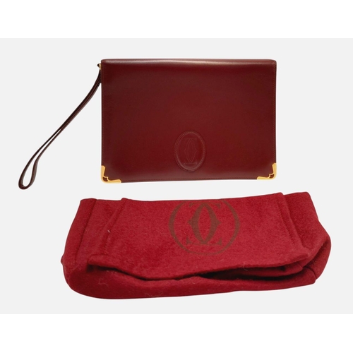 305 - A Cartier Burgundy Must de Cartier Wallet. Burgundy leather exterior, featuring gold-toned hardware ... 